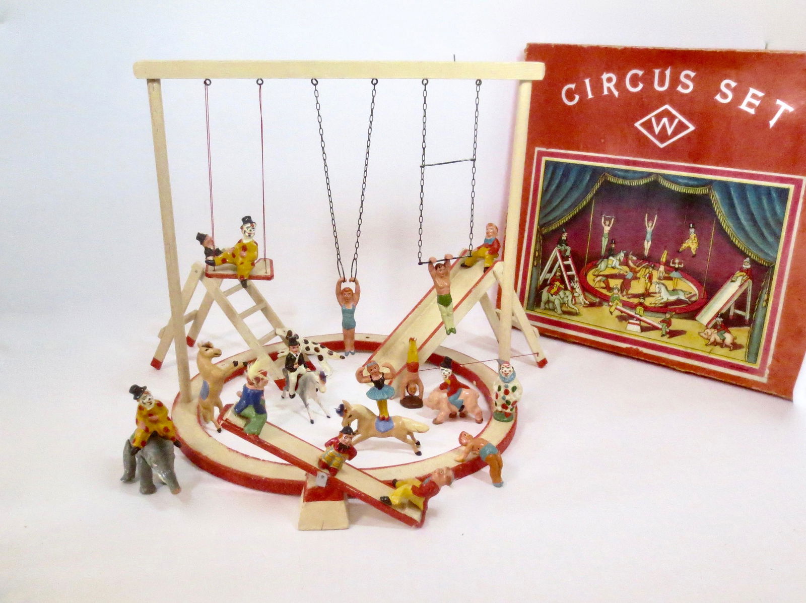 RARE German Composition Circus Boxed Set: Whimsical composition clowns, acrobats, and animals, with wooden ring and accessories. 25 pieces. Excellent condition (a few leg repairs on horses). Comes in original illustrated box. Box good, with s