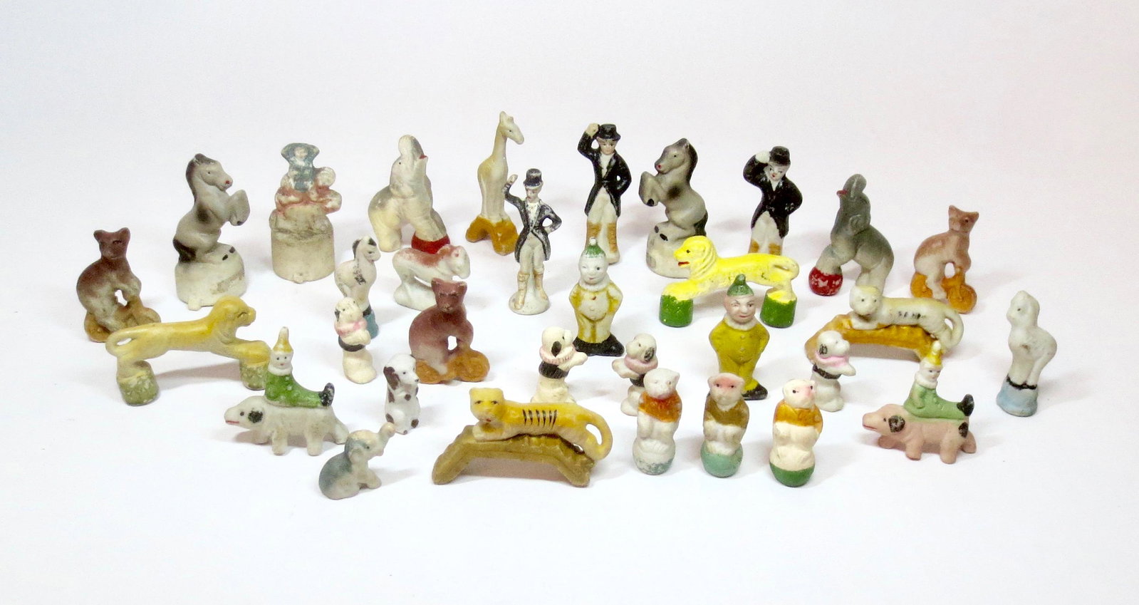 Porcelain Circus Figures: Large assortment of Circus clowns and animals. 25mm-65mm tall. 32 pieces. Excellent condition. Unboxed.