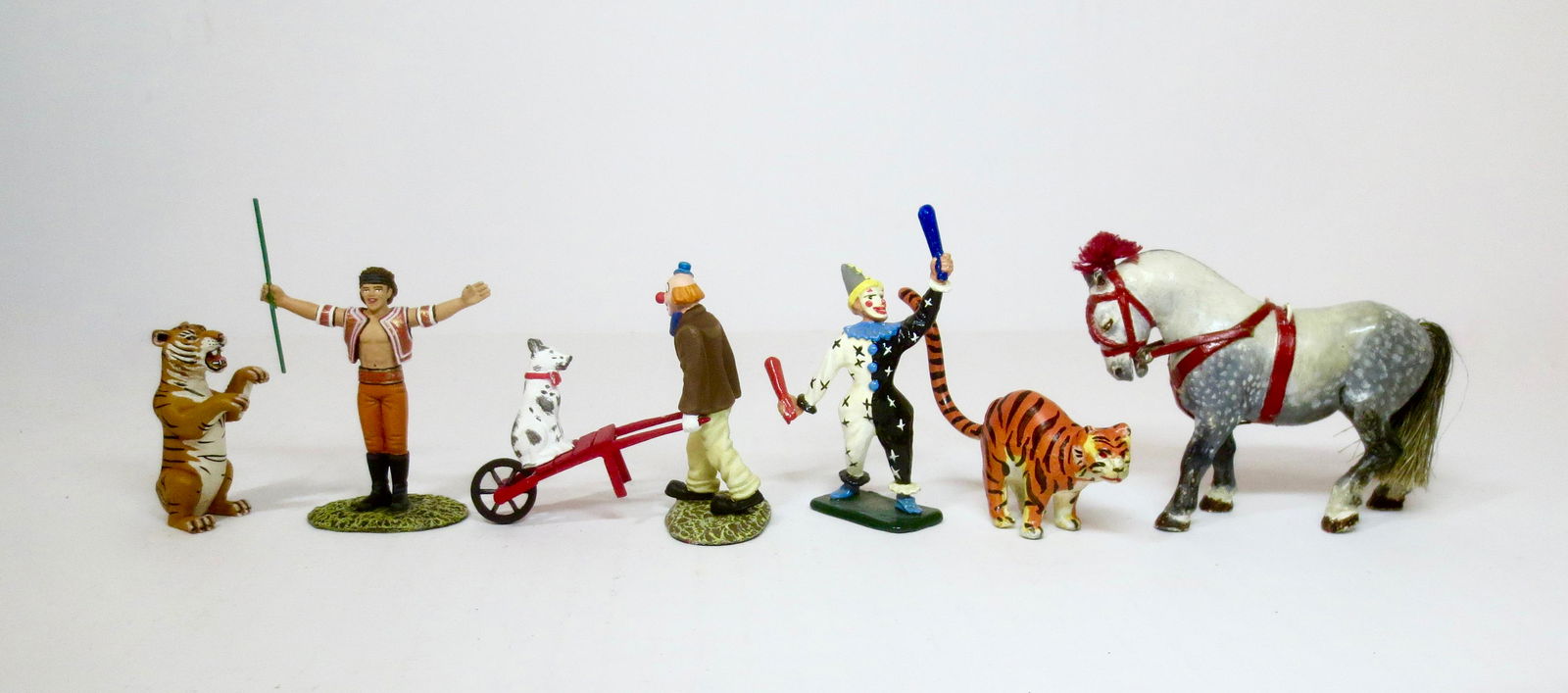 Circus Figure Assortment: Clowns, animal trainer, tigers and circus dog from Patrick Campbell and other makers. 8 pieces. Excellent condition. Unboxed.