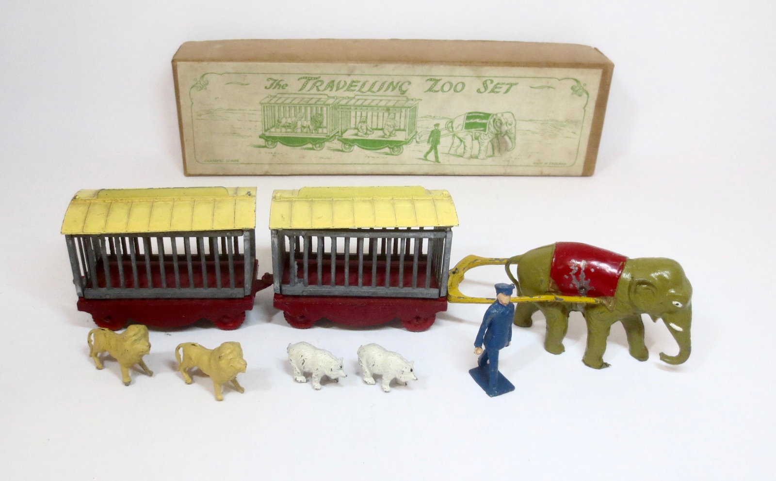 Charbens RARE "Travelling Zoo" Set: Elephant pulling two Animal Cages with Lions and Polar Bears, while Zoo Keeper walks astride the caravan. 8 pieces. Excellent overall condition with some paint wear and a few roof tabs missing on the 