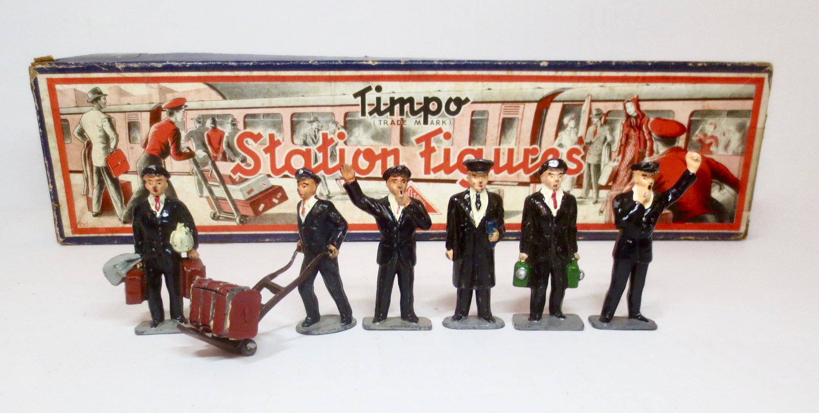 Timpo Railway Set: Complete set with Station Master and Porters carrying Luggage. 8 pieces. Excellent condition. Box good, with general age wear.