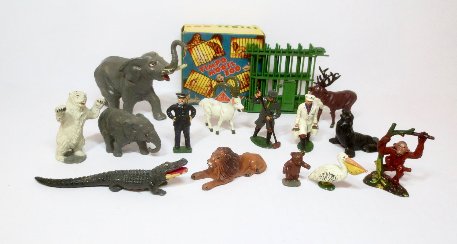 Timpo Model Zoo Assortment: Includes a boxed set with Stag, Mountain Goat and cage. Plus a wide selection of animals, and trio of Zoo Keepers. 14 pieces (plus fence). Near mint to excellent condition. Box excellent.