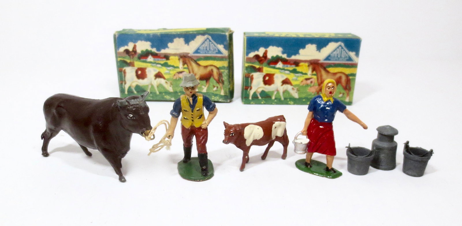 Timpo Farm Picture Packs: Farmer with Bull, and Milkmaid with Calf, Churn and Buckets. 7 pieces. Near mint in original illustrated boxes. Boxes excellent.