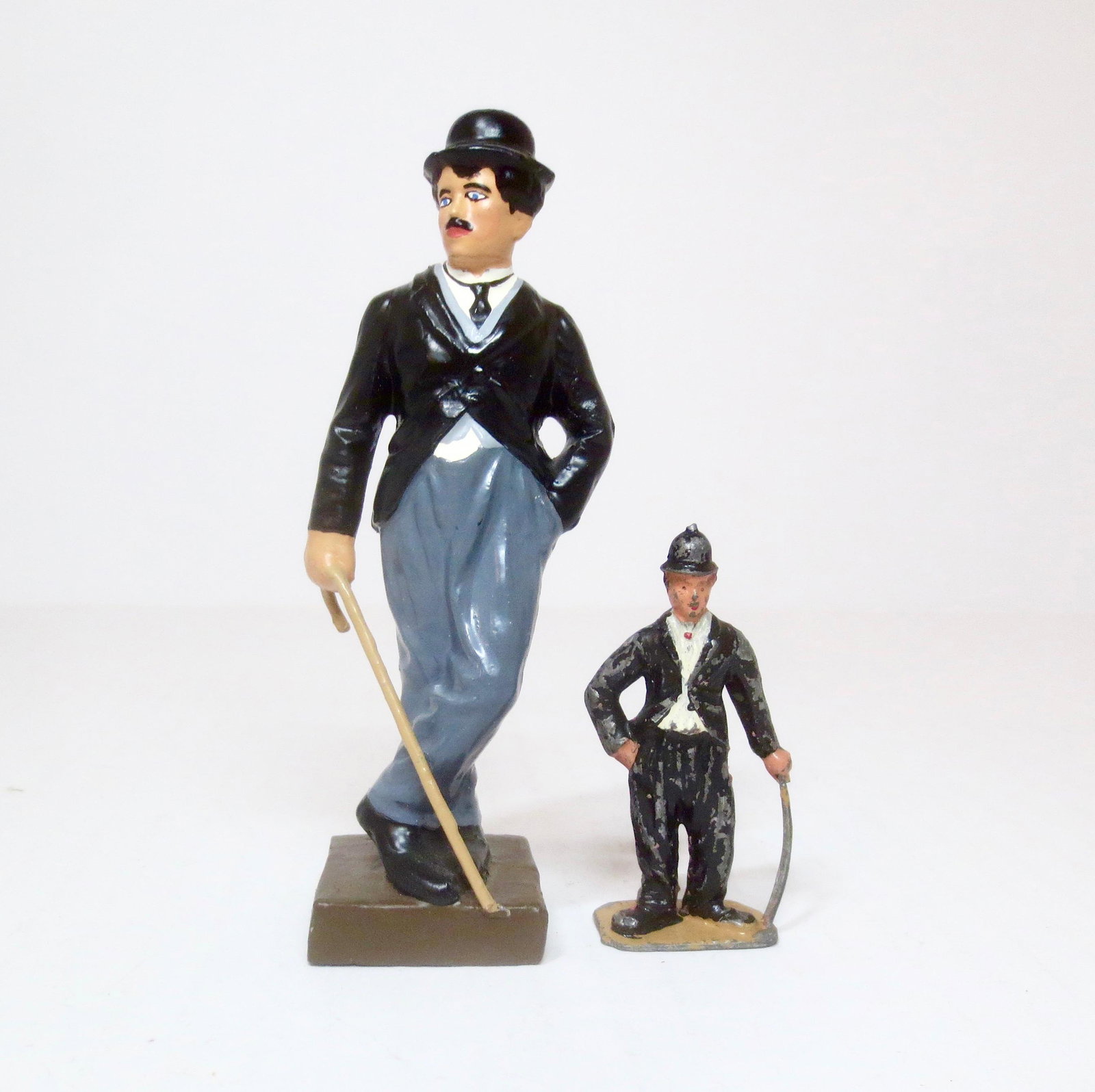 Charlie Chaplin Figures: Chaplin dressed as "The Tramp". Large figure measures 111mm, small figure is 54mm. Excellent condition. Unboxed.