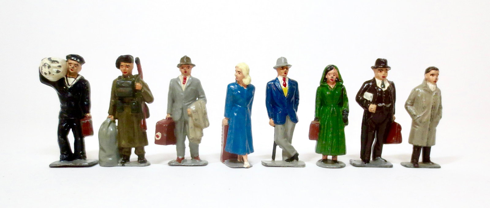 Timpo Railway Train Passengers: Scarce Navy and Army figures, Commercial traveler, Mr. & Mrs. Smith, Mrs. Green, Business man and Boy in an overcoat. 8 pieces. Near mint to excellent condition. Unboxed.