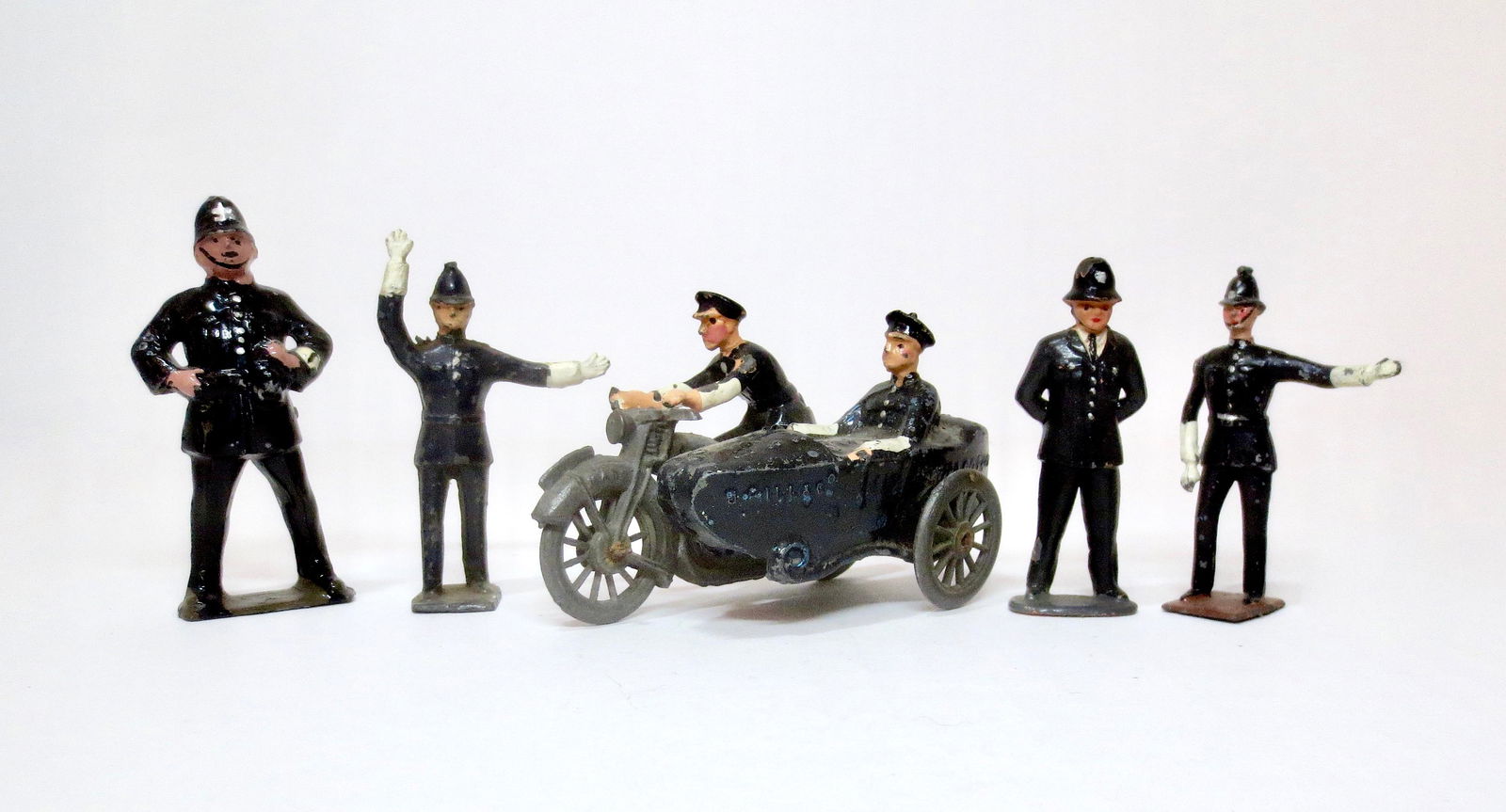British Hollowcast Bobbies and Policemen: Johillco 60mm Bobby and 54mm Police Motorcycle with side car, plus Bobbys from Britains, Reynolds, and Crescent. 5 pieces. Excellent condition. Unboxed.