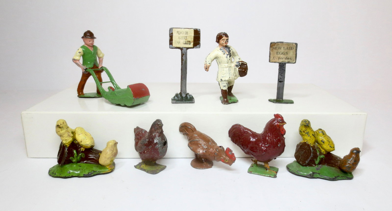 Pixyland Farm & Garden Figures: Gardener with lawn mower, Farm Girl with Basket, Close the Gate & Fresh Eggs signs, and an assortment of Roosters, Hens, and Chicks. 9 pieces. Excellent to good condition, with some paint wear. Unboxe
