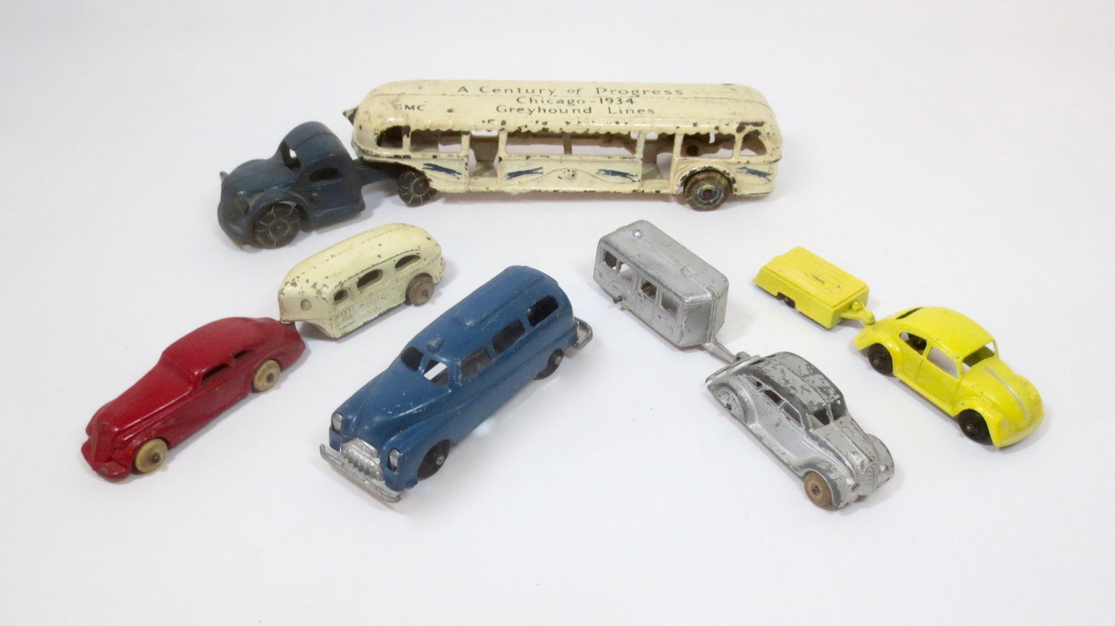 Dimestore Toy Transportation Vehicles: Arcade Century of Progress Greyhound Bus. Plus Midgetoy, Tootsie Toy, Barclay and Manoil slush & diecast cars with trailers. 8 pieces. Excellent to good condition (Manoil chassis comes loose from the 