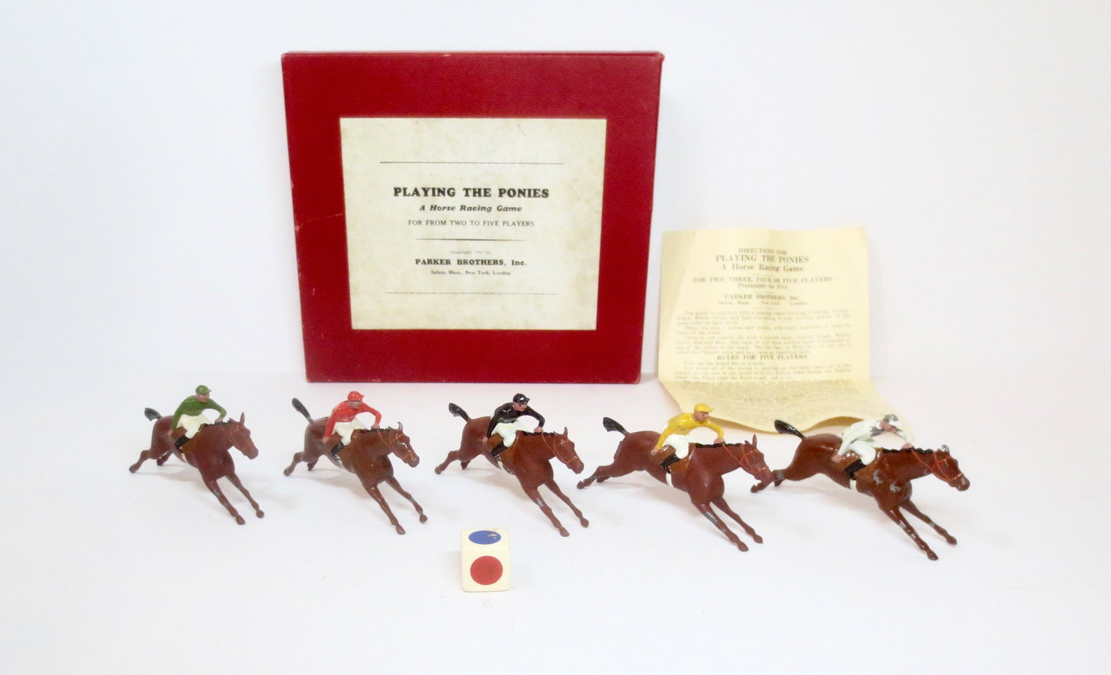 Britains "Playing the Ponies" Race Horse Game: Produced for Parker Brothers. Circa 1931. 5 Race Horses with Jockeys in Colours. Complete with dice and instructions for game play. Near mint to excellent condition, with some paint chips on horses le