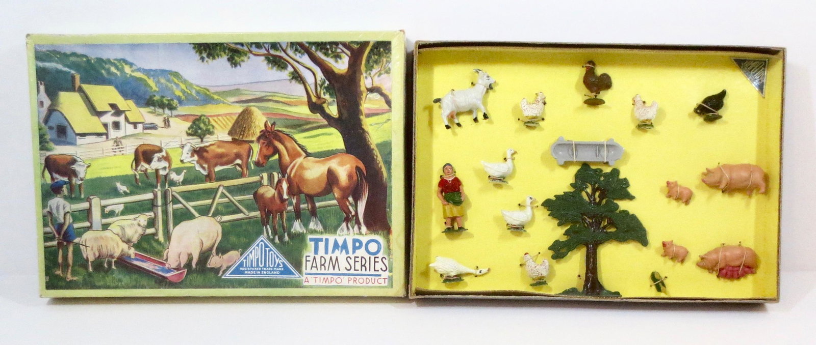 Timpo Farm Set #130: Farm Girl feeding a variety of animals. 17 pieces. Mint condition, tied to card (tree is loose) in illustrated box. Box excellent.