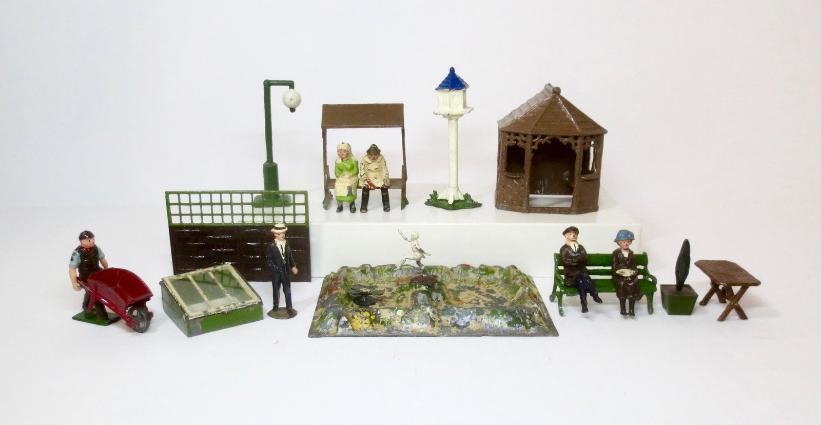 British Makers Farm & Garden Assortment: Johillco seated Farmer and Daughter, Gardener, Birdhouse, Rare Garden House & Table, plus Britains Lily Pond, Window box, and more. 18 pieces. Excellent condition. Unboxed.