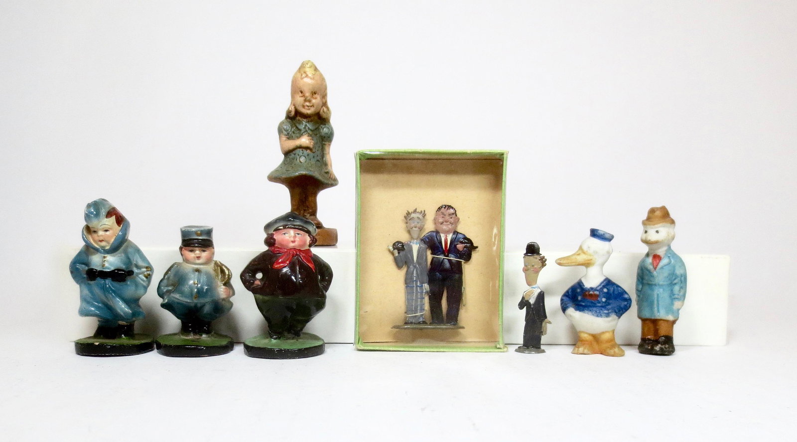 Assorted Comic Figures: Mignot "Laurel & Hardy", Sirocco "Cookie", Porcelain "Donald Duck" & "Mutt", and three chubby comical figures. 8 pieces. Mint to excellent condition.