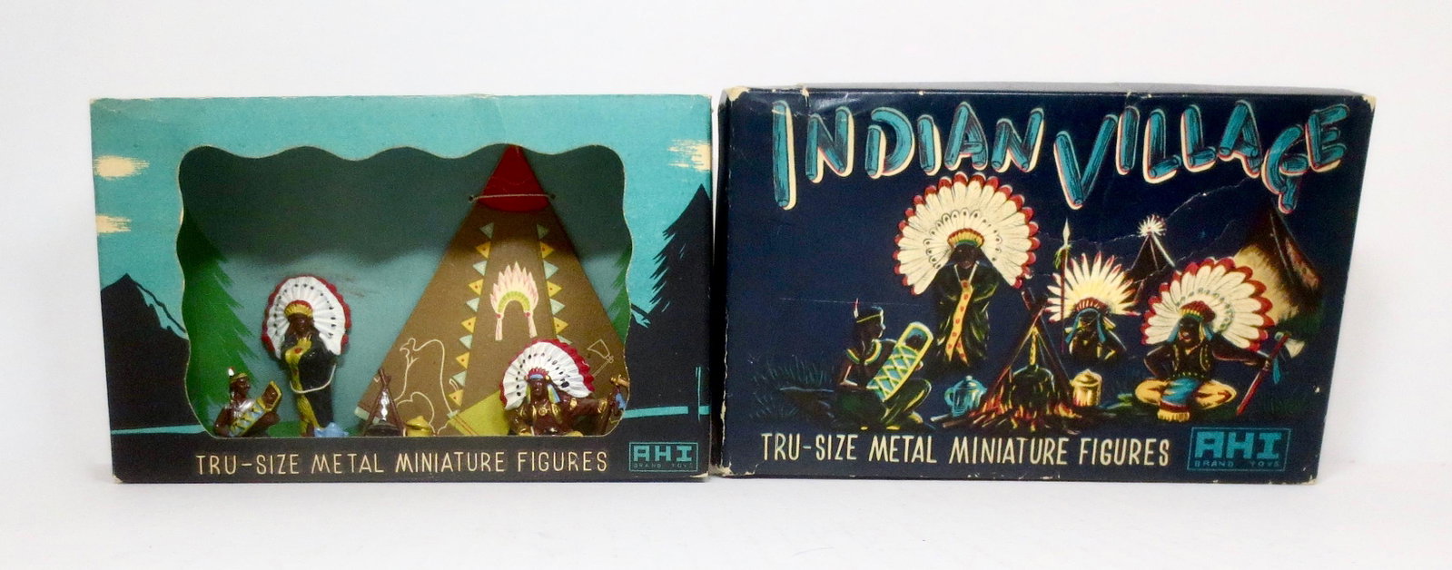 AHI RARE Indian Village Diorama Boxed Set: Chiefs with Squaw holding Papoose by the campfire. 5 pieces. Mint condition, still tied to the card in the colorful illustrated box. Box very good (some edge wear, and one top corner split).