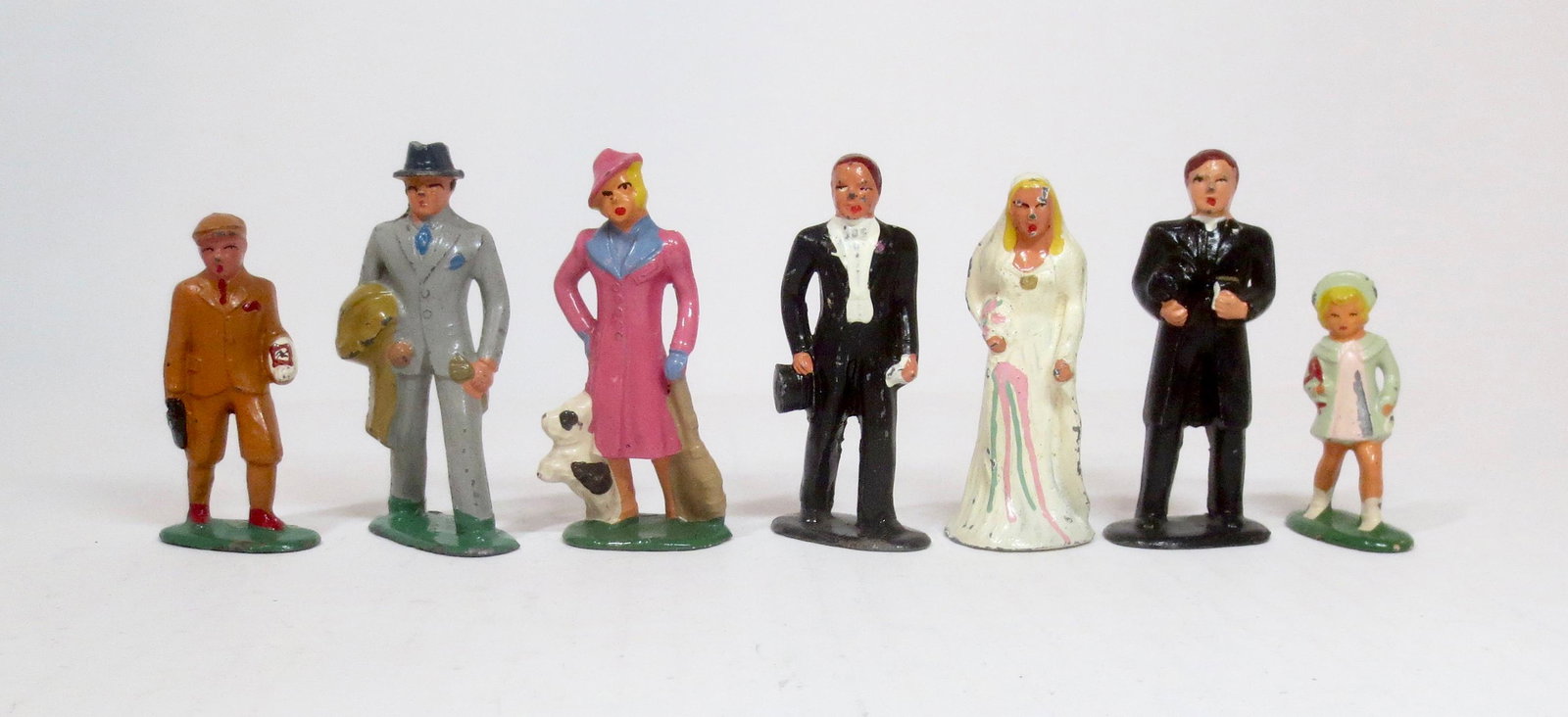 Barclay Civilian Dimestore Figures: School Boy, Business Man, Lady in Pink Dress with Dog, Groom, Bride, Minister, and Girl with Doll. 7 pieces. Excellent condition. Unboxed.