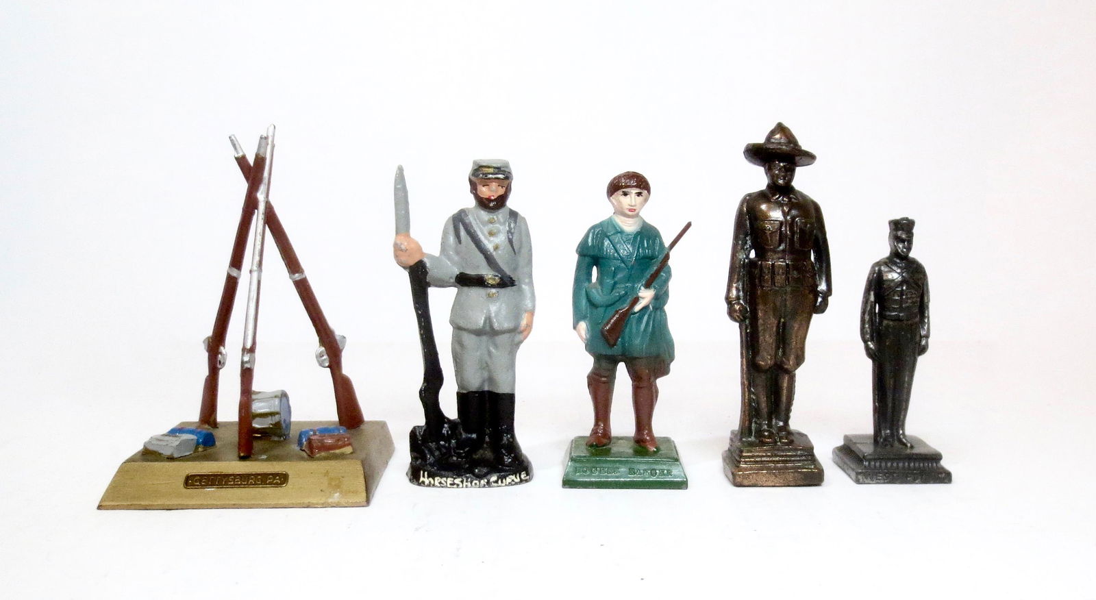 Souvenir Soldier Selection: Souvenirs from a variety of makers and locations. Gun Monument from Gettysburg PA, Confederate from Horseshoe Curve, Rogers Ranger, Doughboy and West Point Cadet. 65mm to 85mm tall. 5 pieces. Excellen