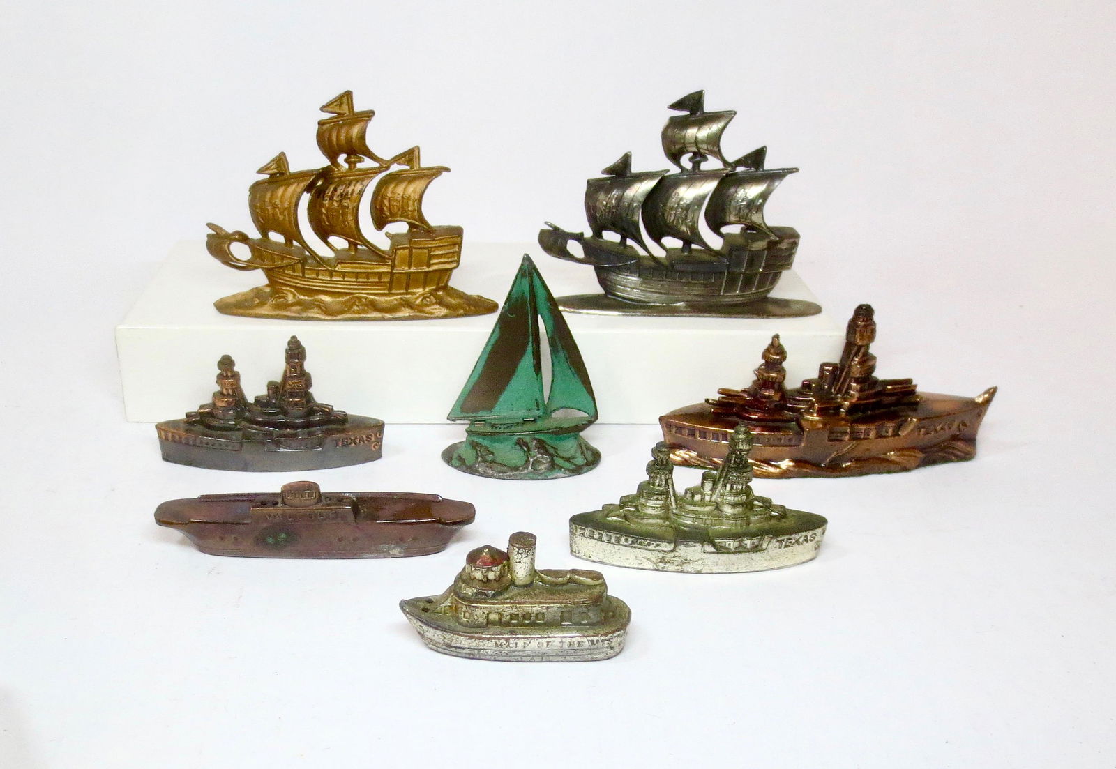 Souvenir Bronze and Pot Metal War Ships: Various makers. 1" to 3" tall. 8 pieces. Excellent to very good condition. No boxes.