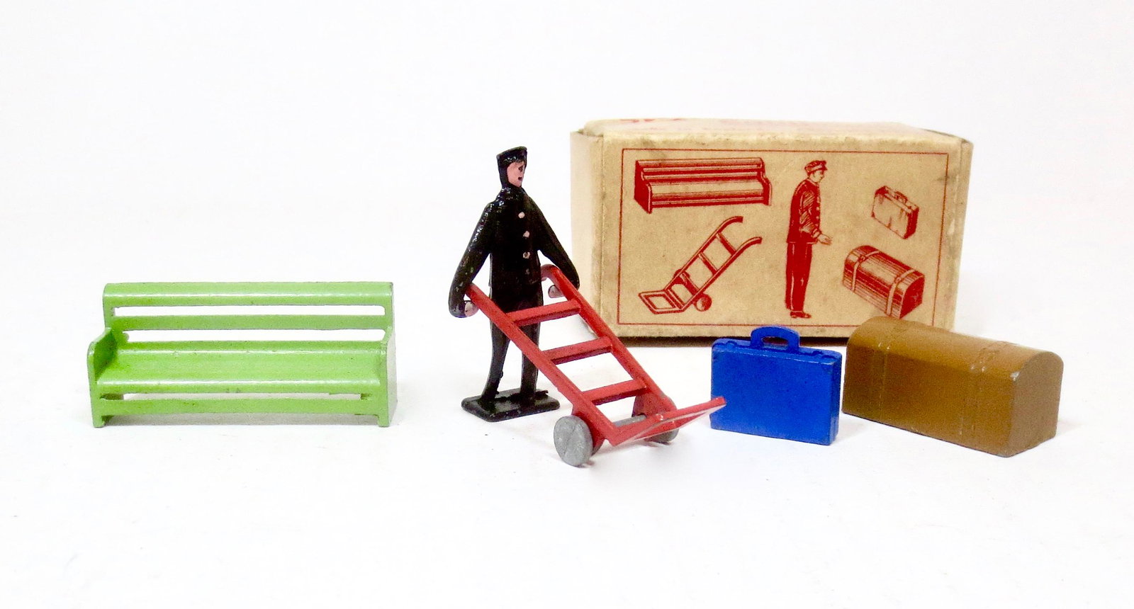 British Station Equipment Boxed Set: Porter, dolly with luggage, and bench. 5 pieces. Near mint condition. Box excellent.