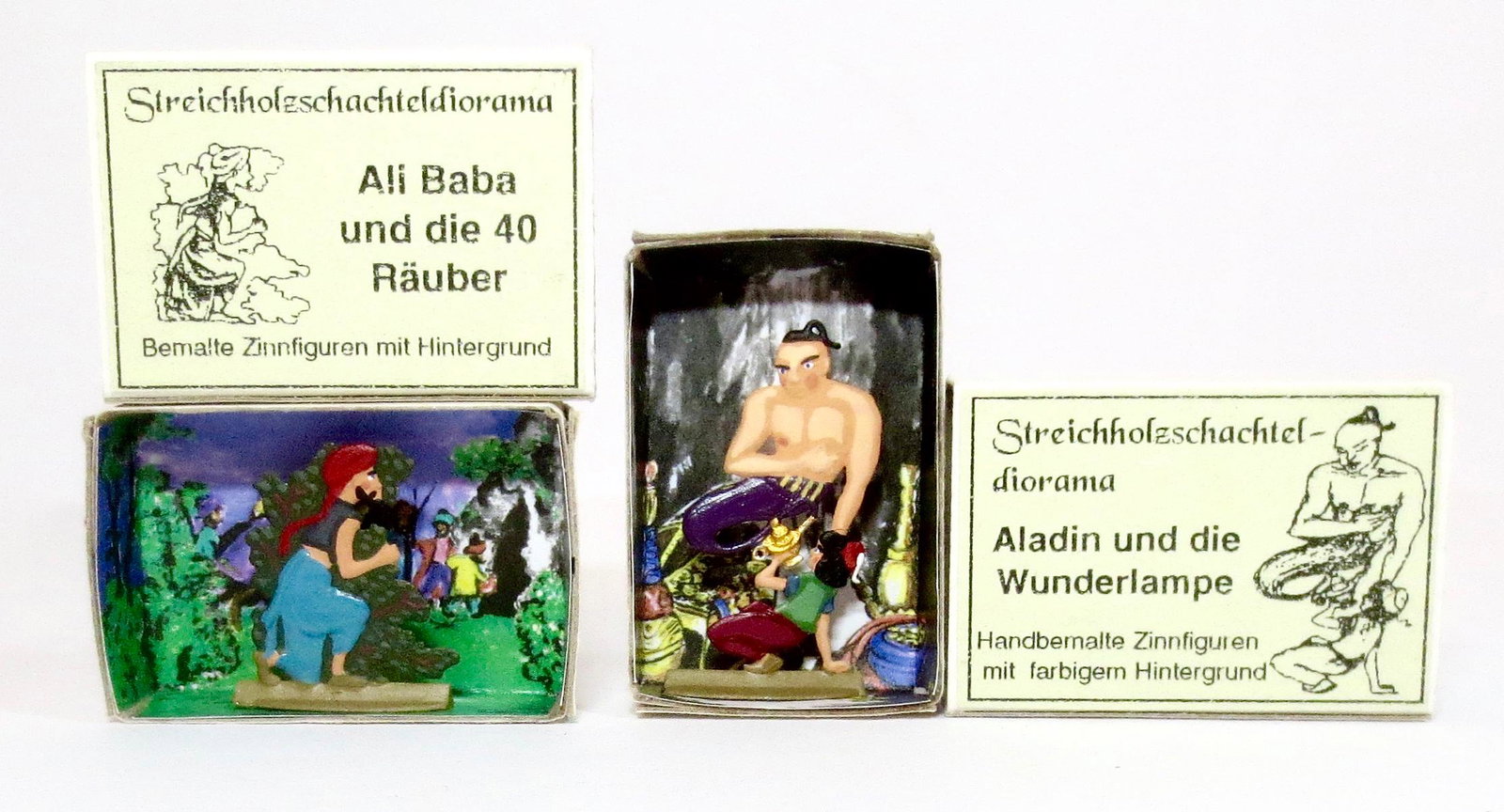 Bemalte Zinnfiguren Fairy Tale Tin Flats: Ali Baba and the 40 Thieves, and Aladdin & The Magic Lamp. 25mm to 60mm. 2 pieces. Near mint condition in illustrated diorama boxes. Boxes excellent condition.
