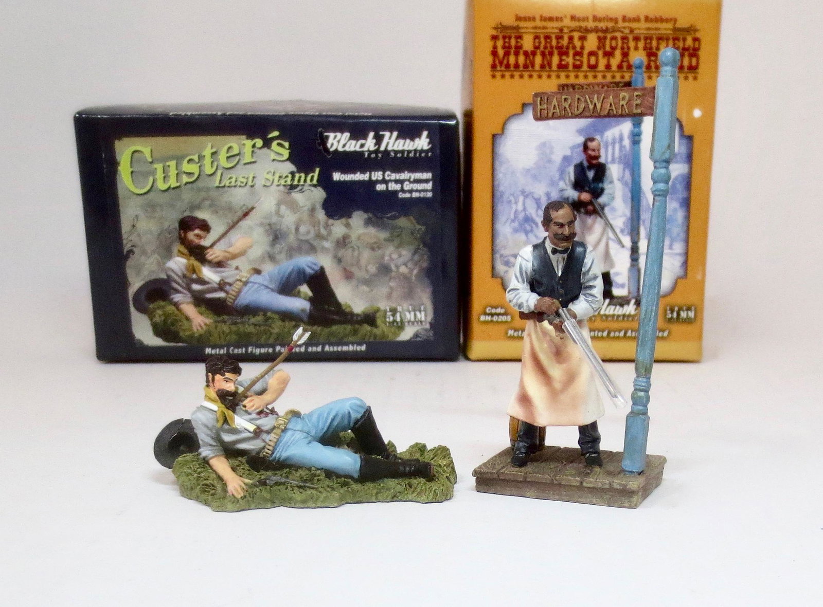 Black Hawk Single Figure Selection: Custer's Last Stand Wounded Cavalryman, and The Great Northfield Minnesota Raid Hardware Store owner with shot gun. 2 pieces. Near mint condition. Boxes excellent.