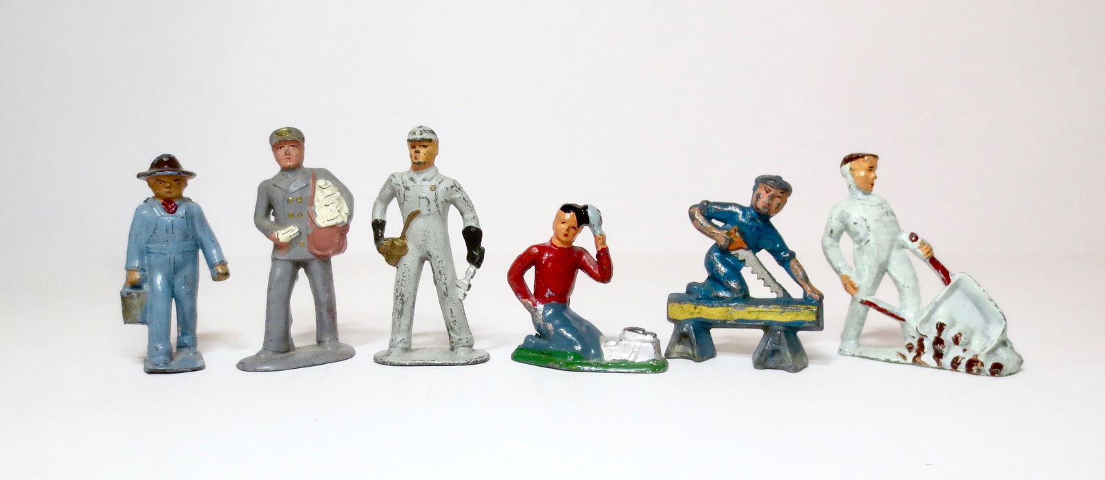 American Dimestore Selection: American Metal Farmer, Barclay Railroad Engineer, Shoe Shine Boy & Mail Man, and Manoil Carpenters. 6 pieces. Very good to good condition, with some paint loss.