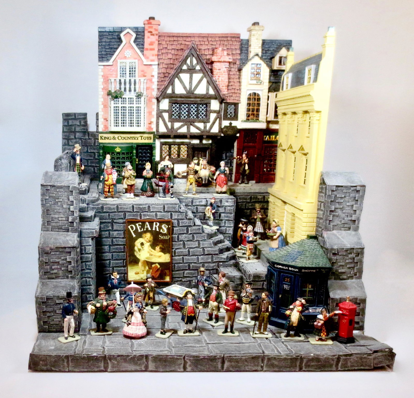 King & Country "Dickens" Collection: Stunning display set including characters from "A Christmas Carol" and "Oliver Twist", plus K&C building facades and Rare base. 40 total pieces. Near mint to excellent condition (corner of foam base d