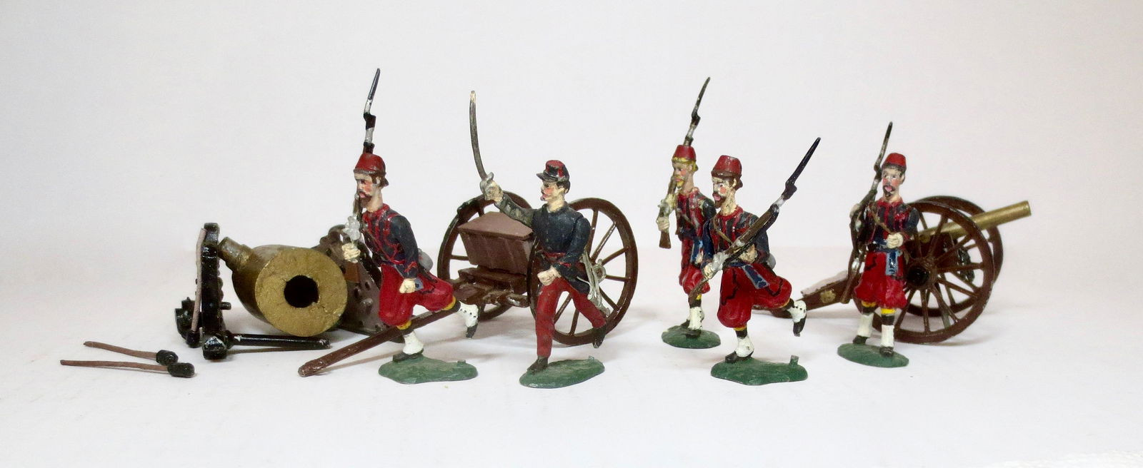 Bussler American Civil War Zouaves: Field cannon, limber, and broken mortar. Plus five Zouaves charging. 8 pieces. Excellent to good condition (cannon loose from base). Unboxed.