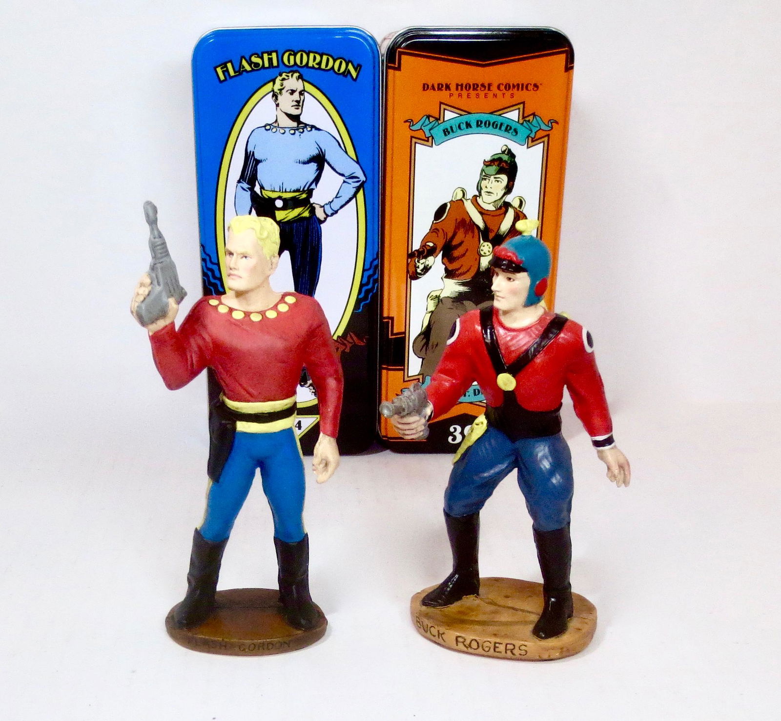 Flash Gordon & Buck Rogers Figures: Two of the most popular comic strip science fiction heroes. 5-1/2" tall. Mint condition. Tins in excellent condition.