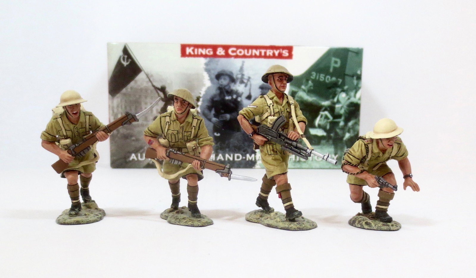 King & Country #EA009 "Advance Under Fire”: A crouching British officer pistol in hand, leads his men towards the enemy. Two additional desert “Tommies” follow their officer with Lee Enfields and fixed bayonets. Backing them up is an advanc