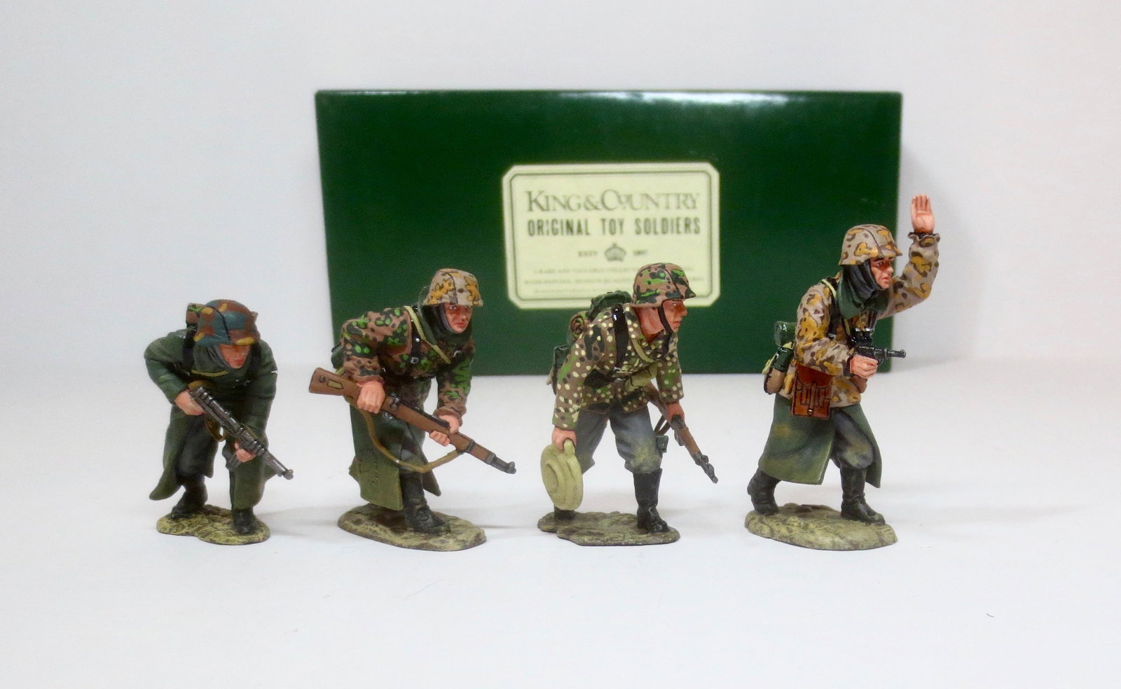 King & Country #WS048 "Advance to Attack": Led by a pistol carrying officer, three SS Panzer Grenadiers cautiously move forward. Retired set. 4 pieces. Near mint condition. Box excellent.