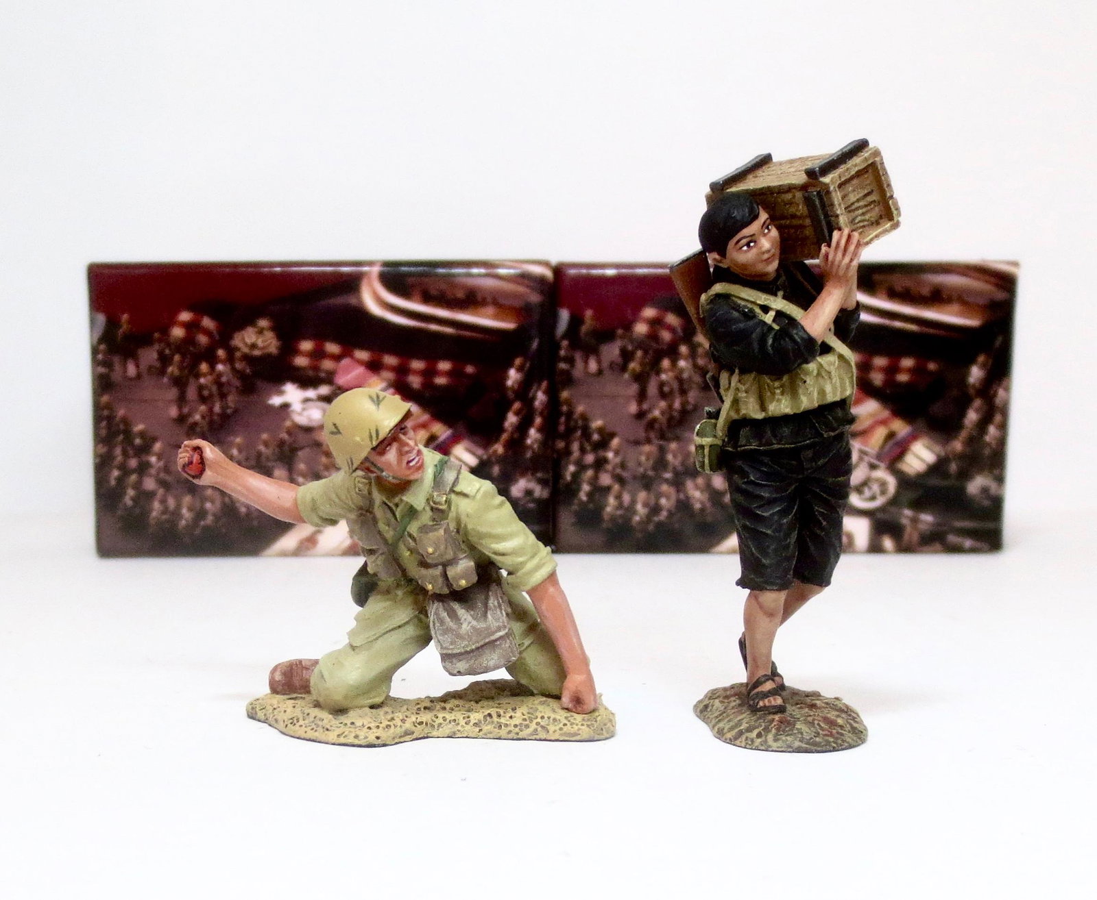 King & Country Boxed Single Figures: Includes an Italian Infantry man #IF043, and a Vietnamese woman #VN023. 2 pieces. Mint condition. Boxes excellent.