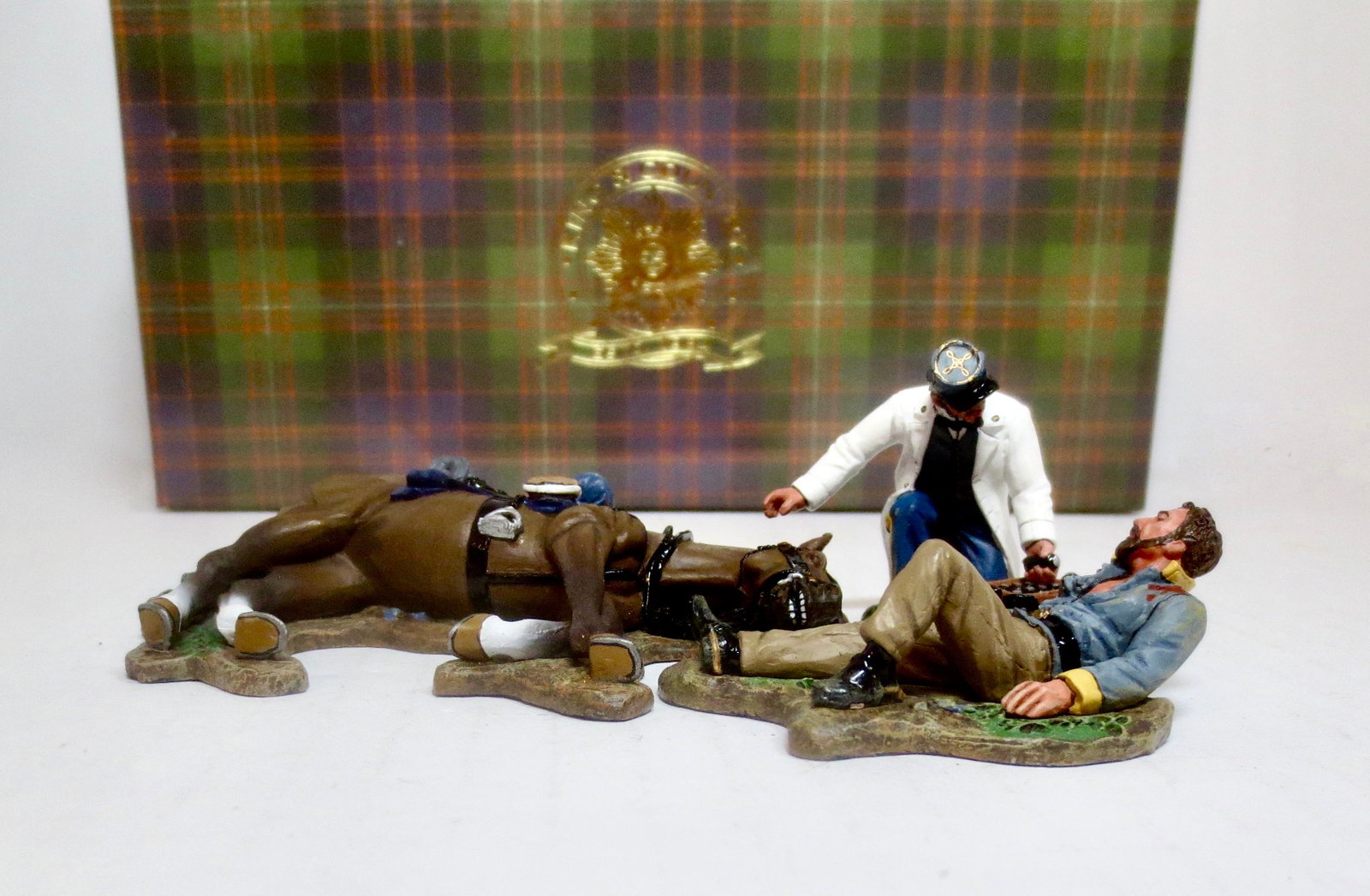 King & Country #CW049 "Battlefield Surgeon": Retired set. A Confederate Army doctor tends a seriously wounded cavalryman propped up against his dead mount. 3 pieces. Mint condition. Box excellent.