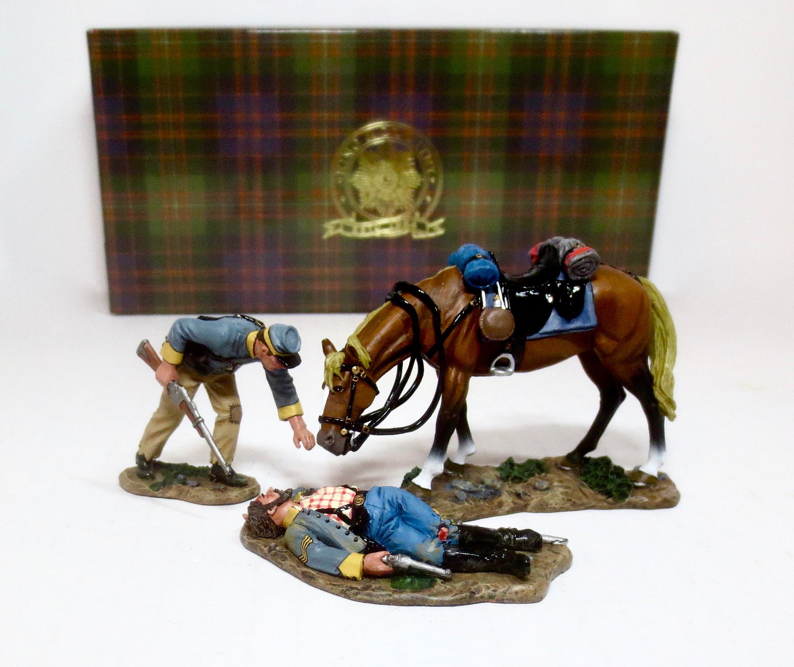 King & Country #CW048 "Helping A Friend": Retired set. A Confederate trooper dismounts to examine a fallen comrade as his forlorn horse looks on. 3 pieces. Mint condition. Box excellent.