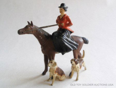 Heyde Huntswoman Sidesaddle on standing Horse: Heyde Huntswoman Sidesaddle on standing Horse with two Fox Hounds at feet. 54mm Scale. Pre War German. Circa 1930.1 Piece. Condition Excellent