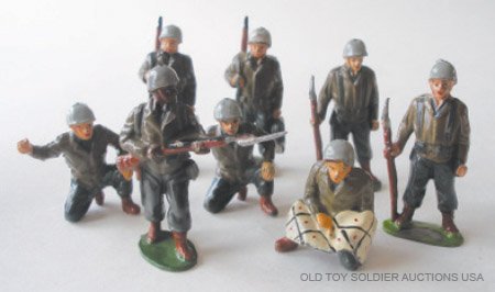 Timpo GIs. RARE Black GI standing on Guard: Timpo GIs. RARE Black GI standing on Guard, Two Marching, Two Standing at Ease, Seated Officer with Map and Two Mortar Operators. Post War 1950. 8 Pieces. Condition Excellent.