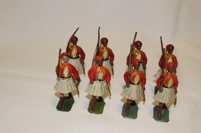 Britains set #196 Greek Evzones: 8 pcs., pre-war, 54 mm, G/VG. mismatched vests, 4 bright red, 4 dark red/scarlet. 1 missing rifle tip.
