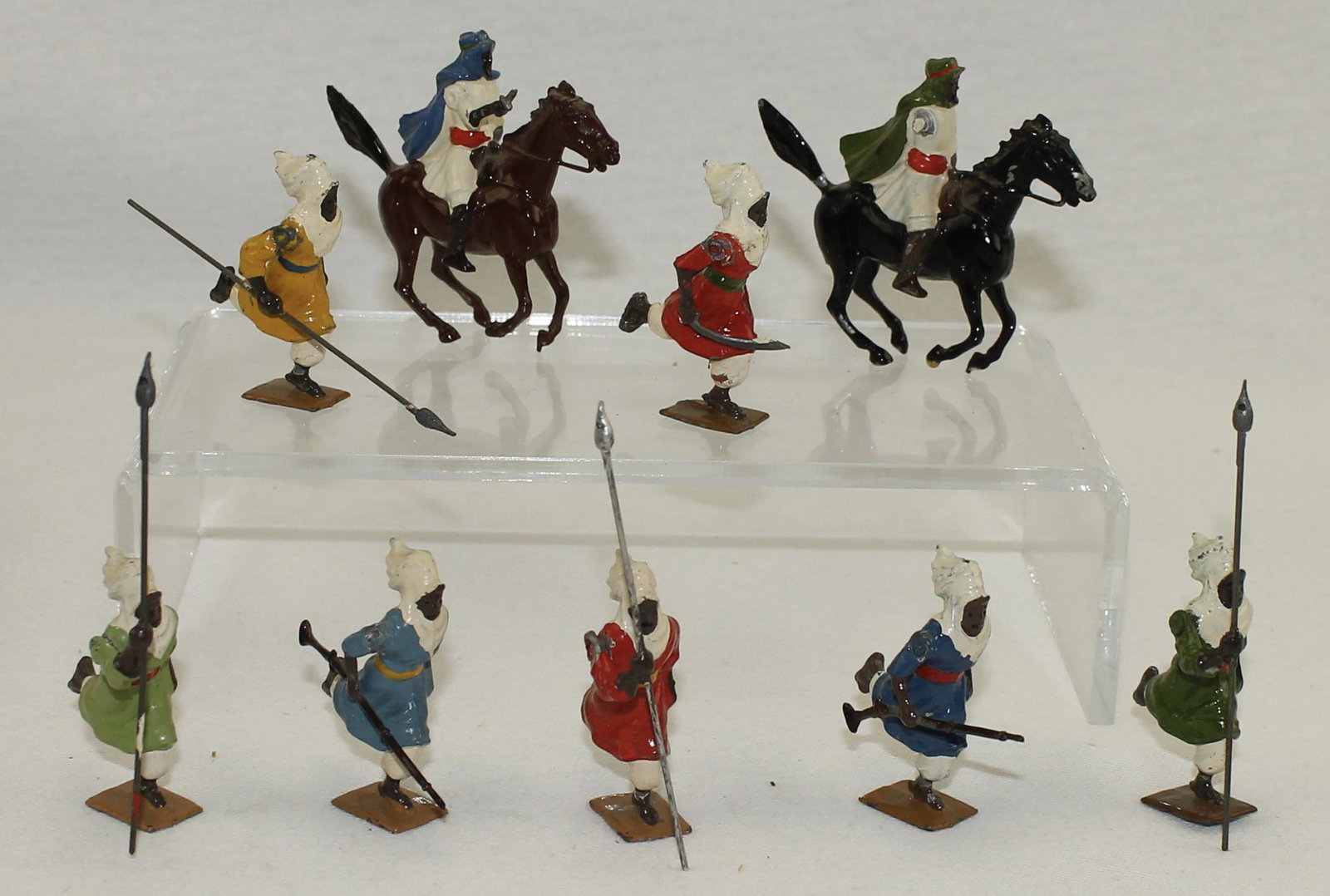 Britains From #2046 Arabs of the Desert: Mounted and Foot. 9 Pieces. Condition Good. One Mounted Rider Missing Arm. One Mounted Rider with Broken Scimitar. No Box.