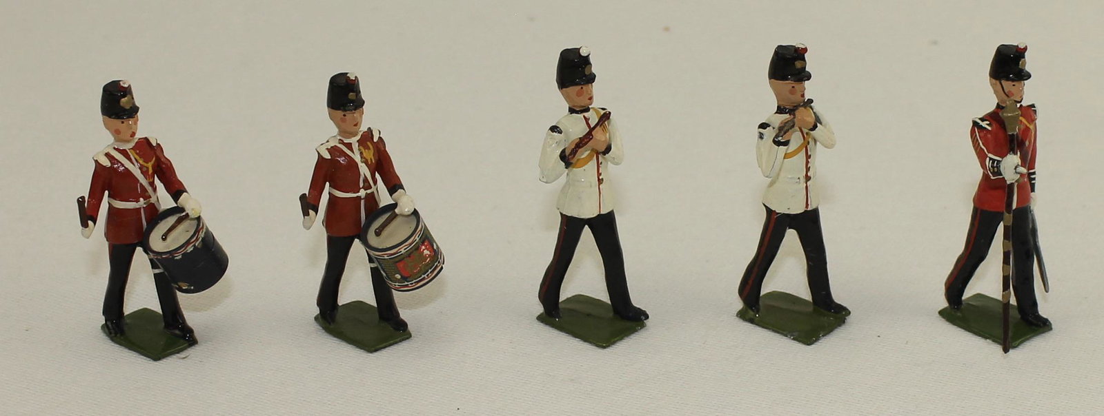 Britains From #2177 Fort Henry Guards Band: 5 Pieces. Condition Very Good. Drum Major's Cuff Embellished. Drum Decal Distressed. No Box.
