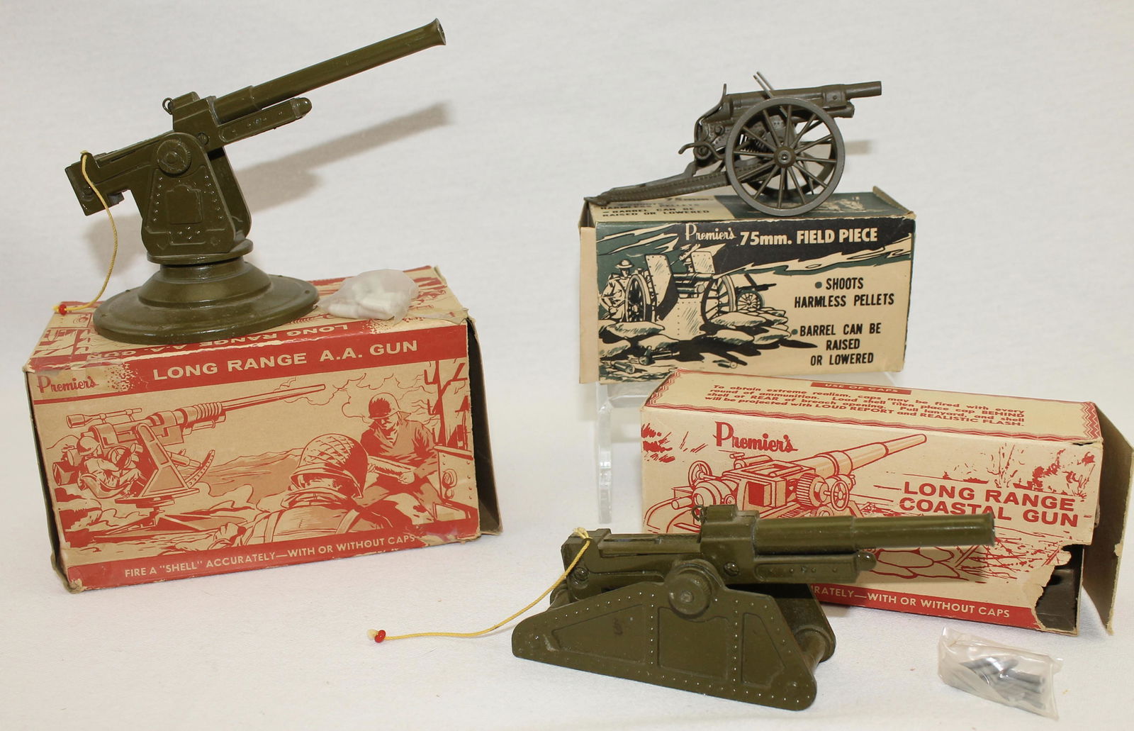Premier's Lot Die Cast Cannons: Lot includes Long Range Anti-Aircraft Gun, Long Range Coastal Gun and a 75mm Field Gun. 3 Pieces. Condition Mint. Boxes Tattered.
