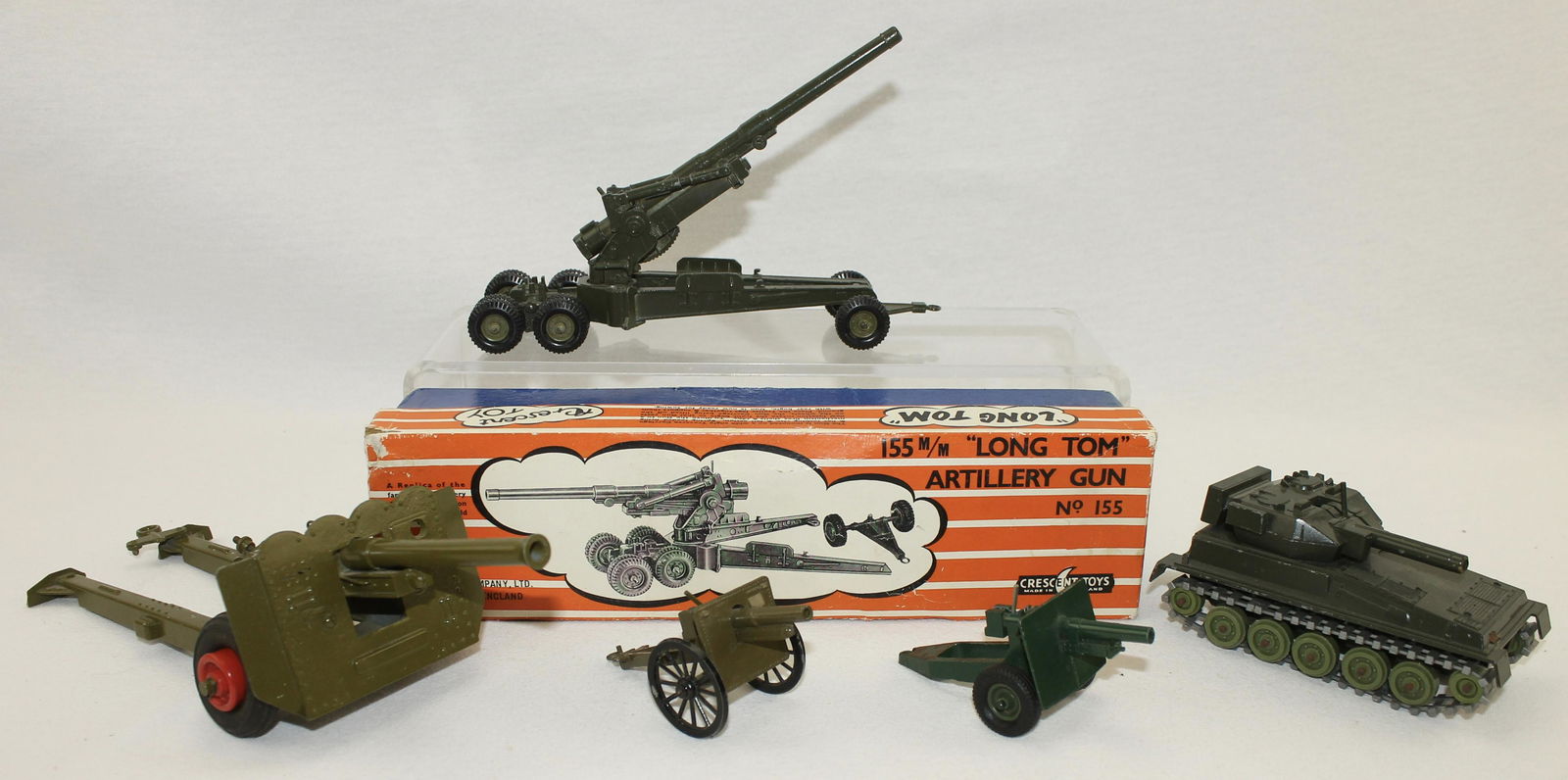 Crescent Cannon Britains Cannon: Lot includes Long Tom Cannon in Box By Crescent, Tank By Crescent, Ben Bros Cannon and Large Field Gun Made in Japan.6 Pieces. Condition Good to Very Good. Box Very Good.