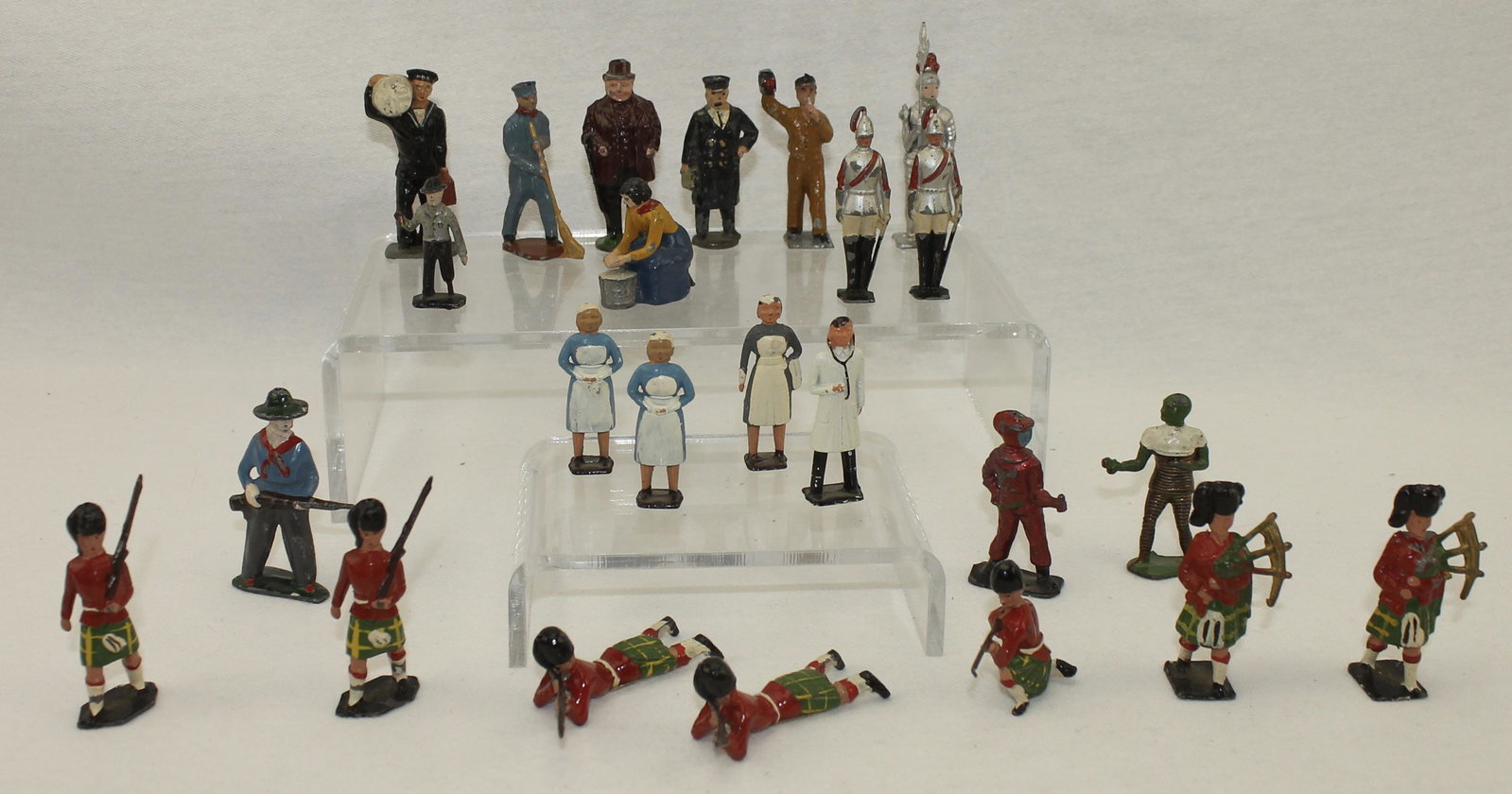 English Lead Figures by Various Makers: Lot includes Doctor, Nurses, Railway Staff and Guards by Various Makers Including Johillco, Crescent, Timpo and Others. 24 Pieces. Condition Good to Very Good. Some Rifle Barrels Broken. No Box.