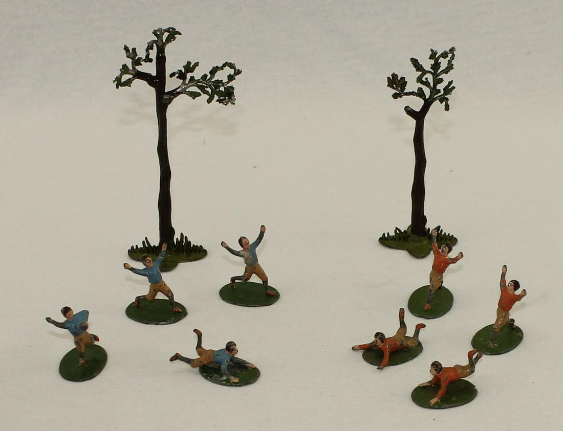Heyde Lot Rugby Players: In Various Positions, One Figure with Ball. 35mm. Marked "Made in Germany" on Bases. Includes 2 Heyde Trees. 10 Pieces. Condition Good to Very Good. Some Damage to Trees. No Box.
