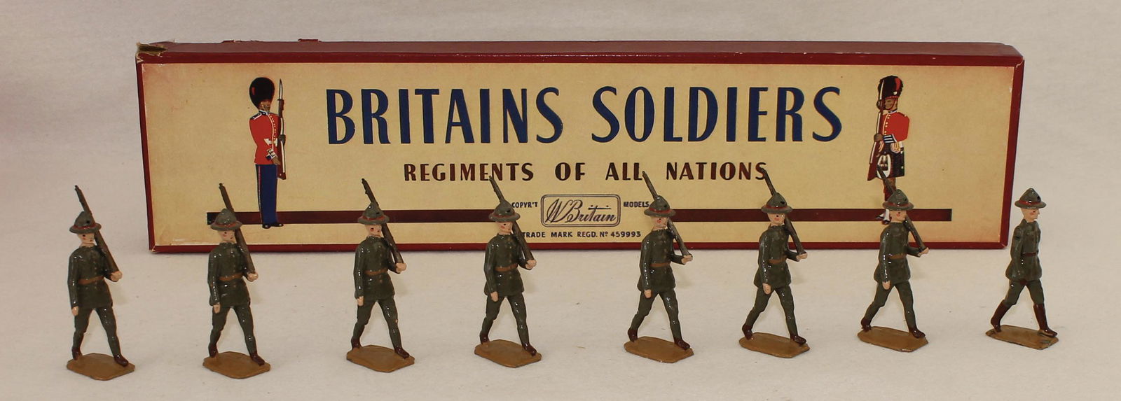 Britains #1542 New Zealand Infantry: Post War. In ROAN Box. 8 Pieces. Condition Very Good to Excellent. Box Good to Very Good. Old Sticky Tape Applied to Box Bottom.