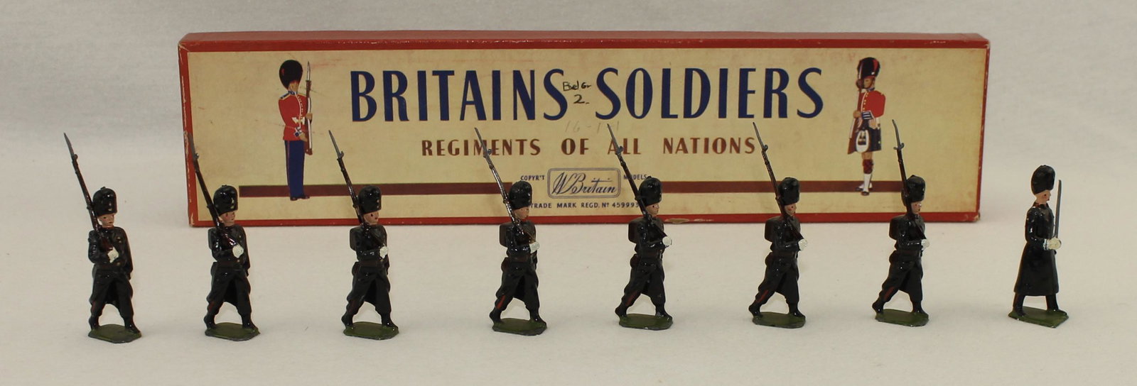 Britains #2009 Belgian Grenadiers: Post War. In ROAN Box. Wearing Greatcoats. 8 Pieces. Condition Excellent. Box Very Good. Ink Graffiti on Label.