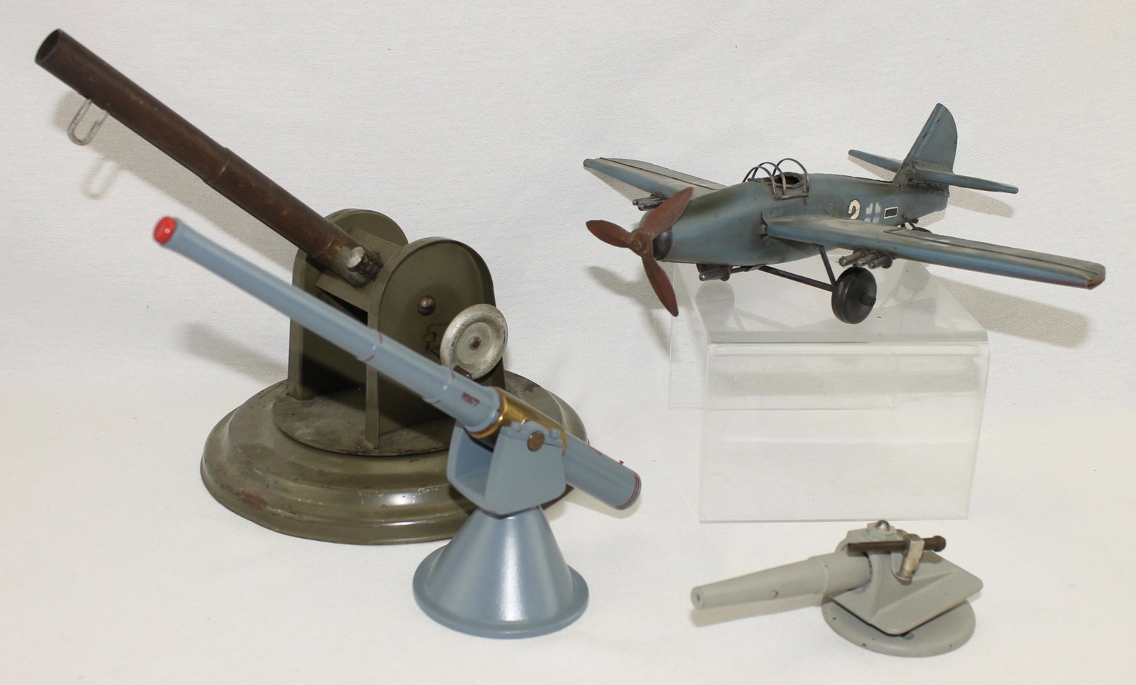 Lot of Machine Metal Cannons German Plane: Lot includes Machined Metal Cannons and a Sheet Metal Folk Art German Fighter Plane. Big Cannon Made by B & B Manufacturing. Base Measures 9" Diameter with 11" Gun Barrel. 4 Pieces. Condition Good to 