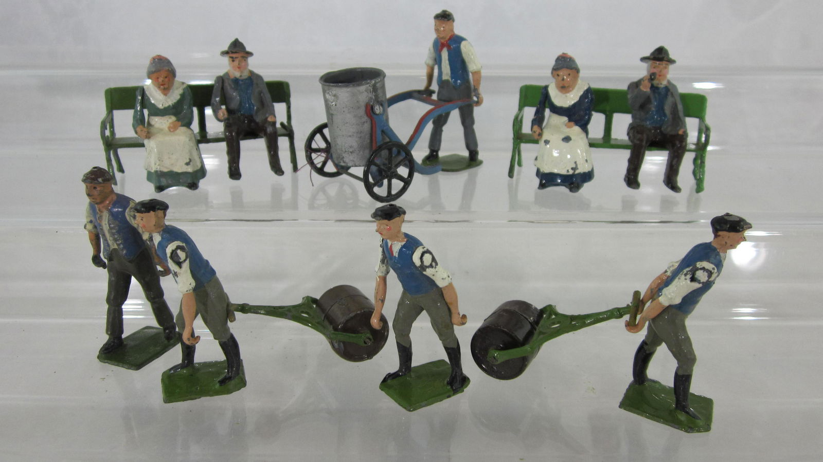 Britains Seated Farm, Tradesmen And Benches.: Post War. UNBOXED Farm folk, tradesmen with farm roller and swing water barrow, and benches. 11 pieces, condition good to excellent, 1 bench rail broken, 2 men have no implements. No box.