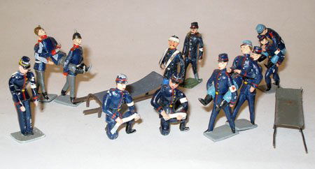 Heyde/Heyde Like Medical Grouping depicting French Army: Heyde/Heyde Like Medical Grouping depicting French Army 1890. Triplex Men carrying wounded, peak caps, triplex Men carrying wounded spiked helmets,Walking wounded with arm in sling, 4 Orderlies and a