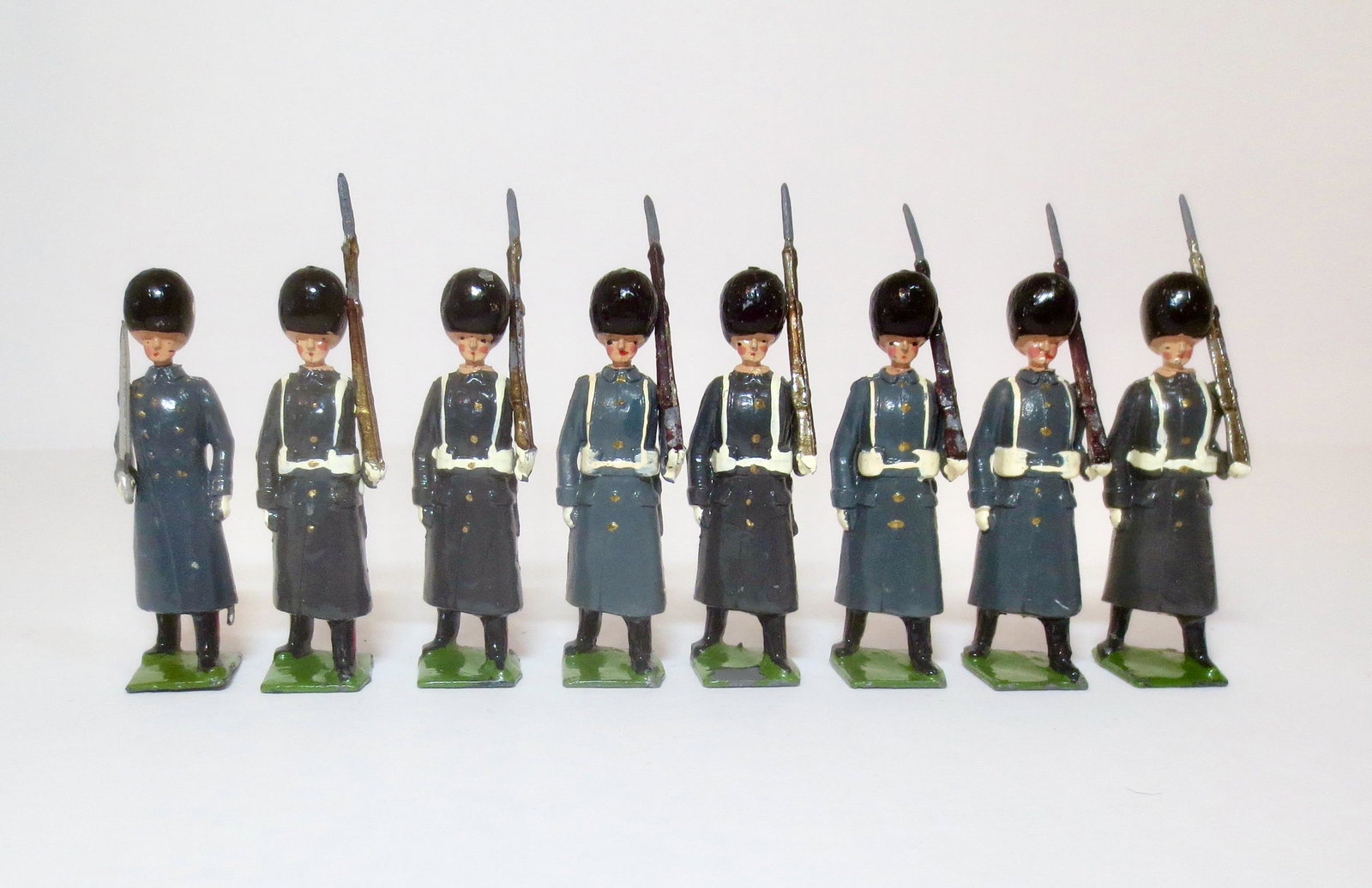 Britains From #312 Grenadier Guards: In Winter overcoats. Post war issue. 8 pieces. Excellent to very good overall condition (mismatched paint, paint chip on one base). Unboxed.