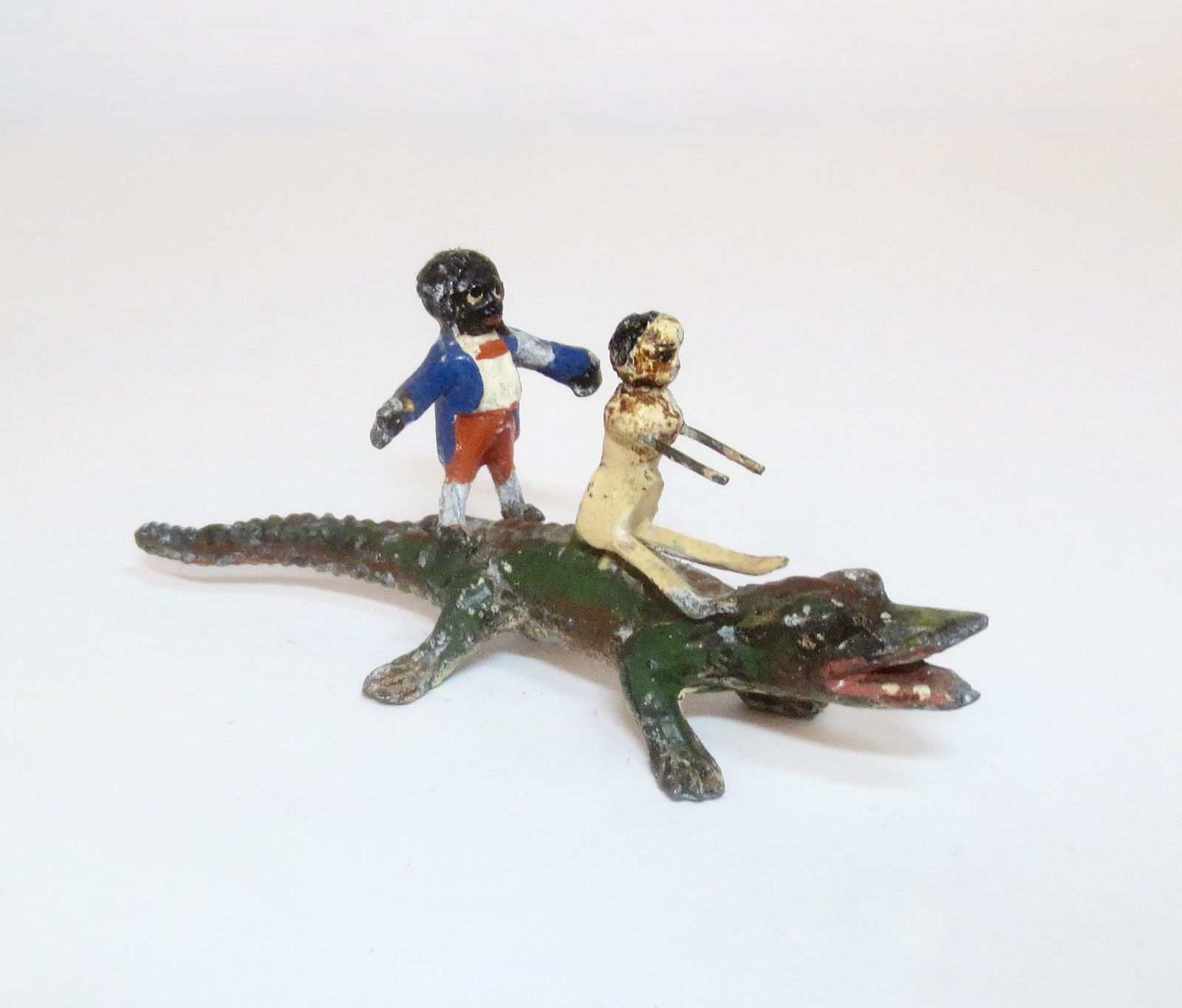 Heyde Golliwog and Peg Doll on Alligator: 90mm long by 35mm tall. Very good condition. Unboxed.