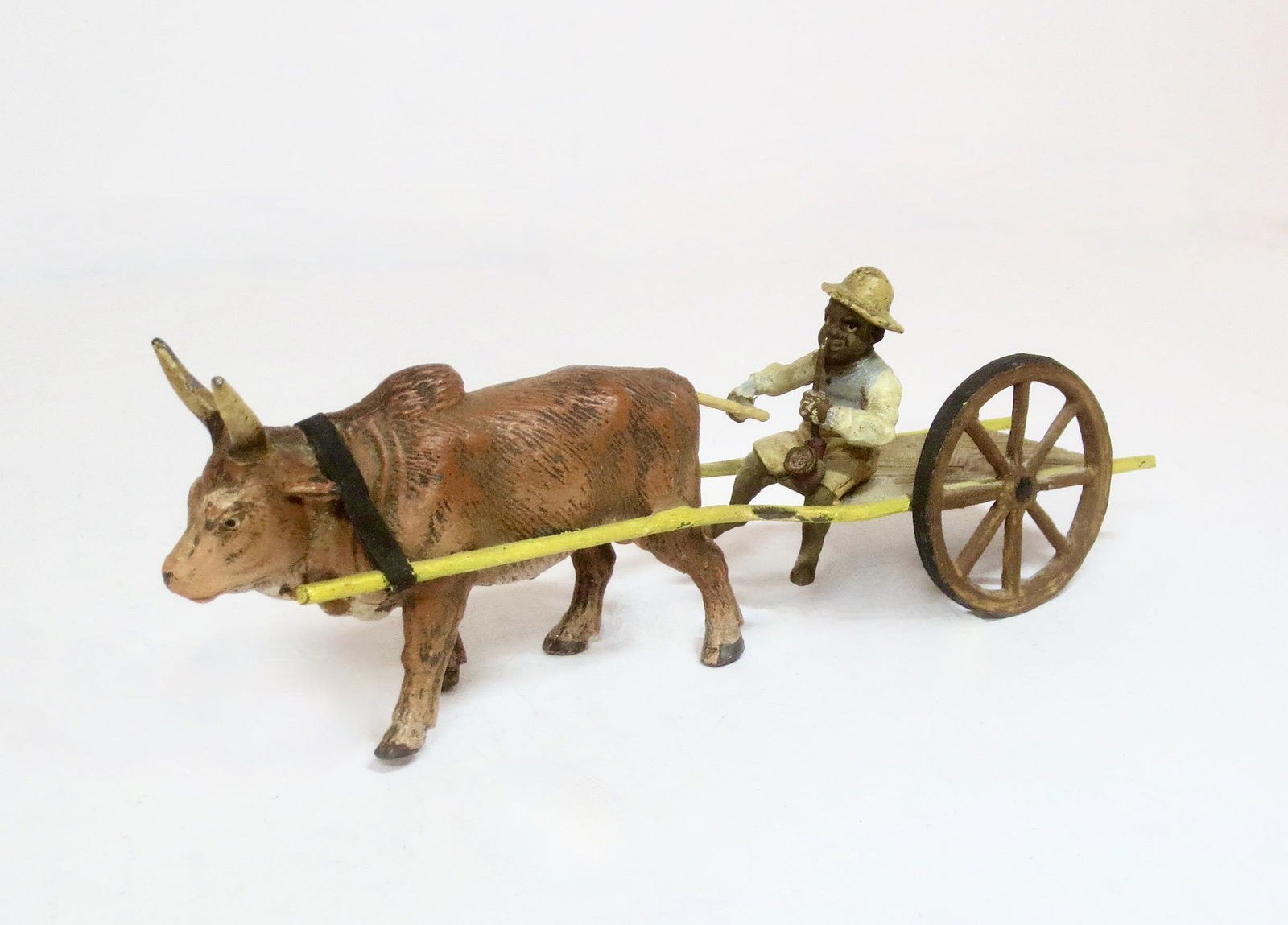 Heyde Black Farmer in Bull Drawn Cart: 1 piece. Measures 2.25" tall by 7" long. Cart is missing one wheel, excellent otherwise. Unboxed.
