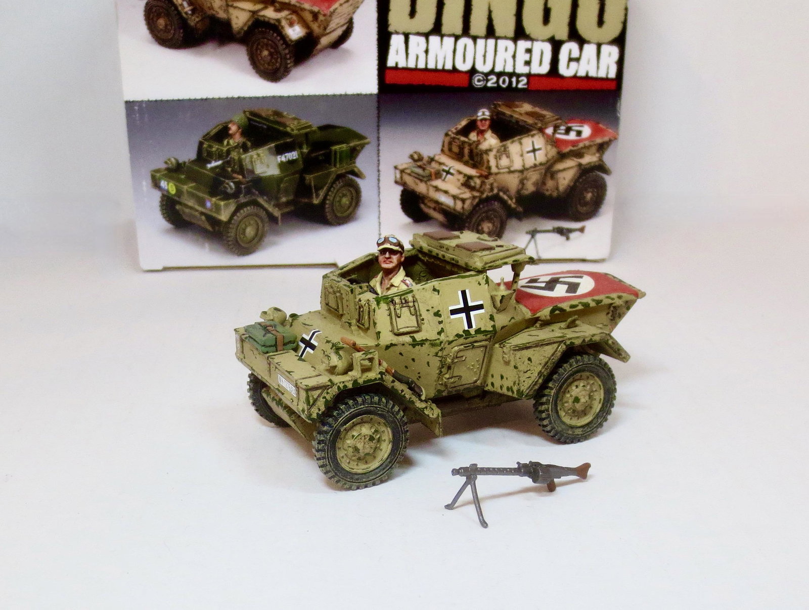 King & Country #AK085 Dingo Armoured Car: Retired set. This former British reconnaissance vehicle now has a “new owner”. It has been painted with large German crosses and a Nazi flag pinned on top of its rear engine cover for air recognit